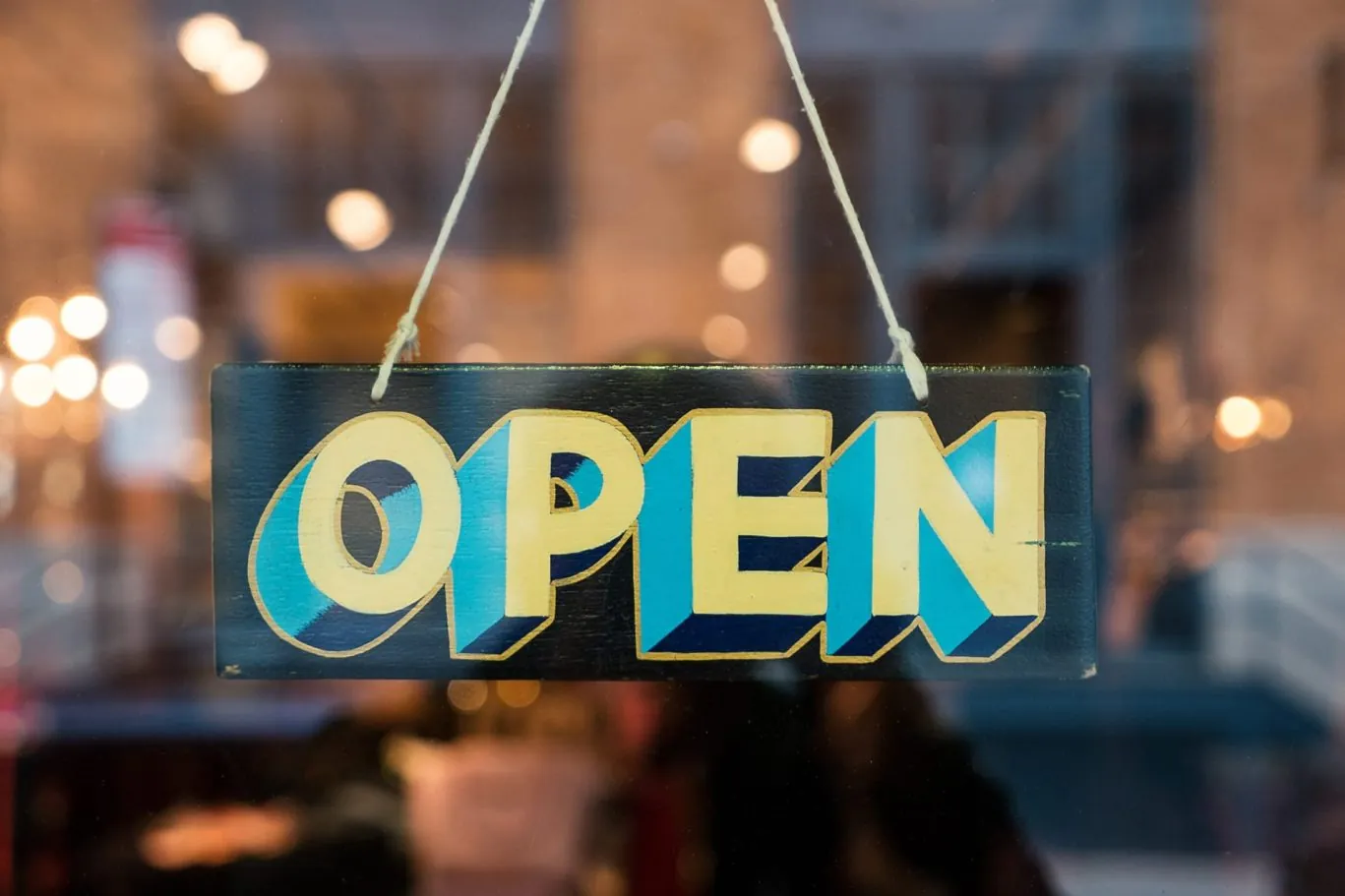 Open sign hanging in window of establishment