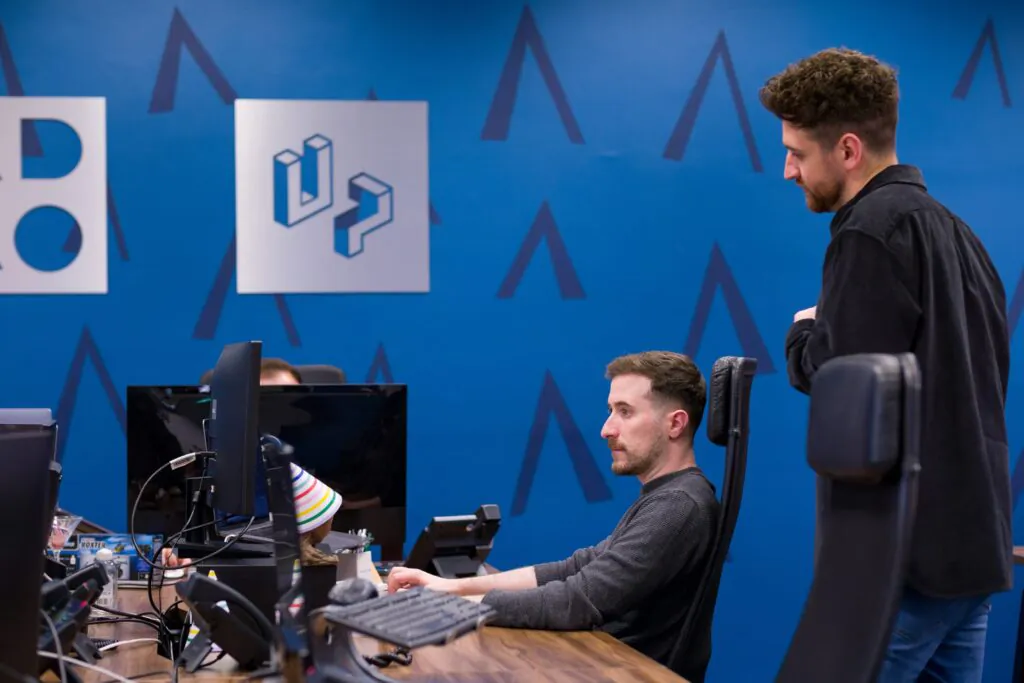 Digital agency team collaborating in an open-plan office, reviewing website development